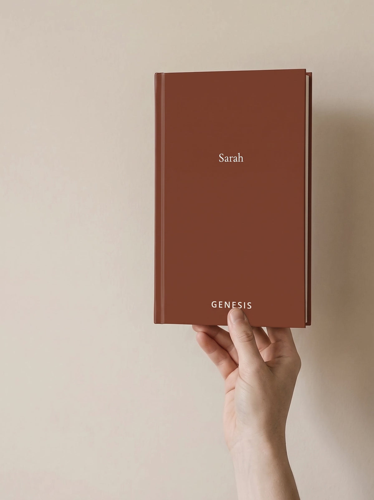 A hand holding the Genesis hardcover, showing how big the book actually is