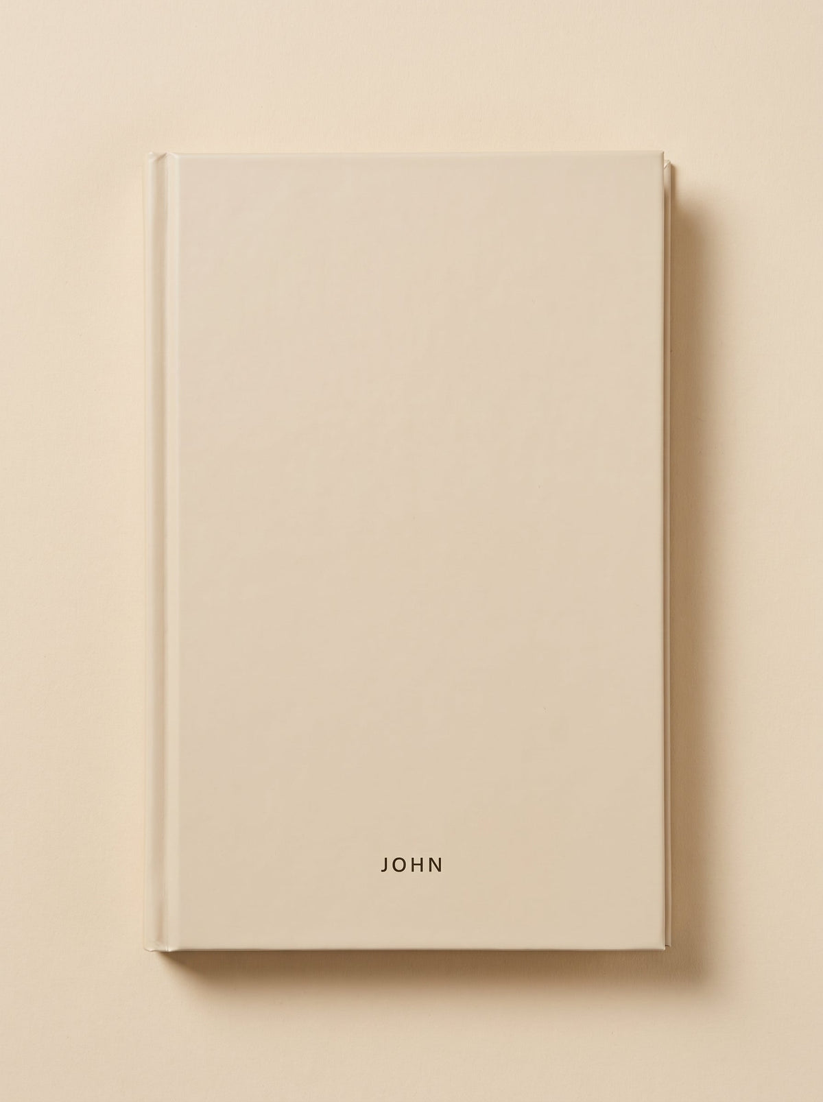 John hardcover in sand, seen from above