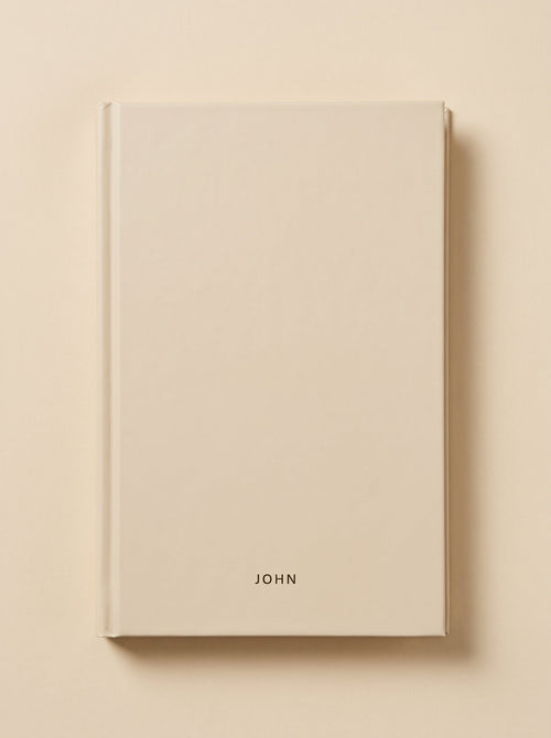 John hardcover in sand, seen from above
