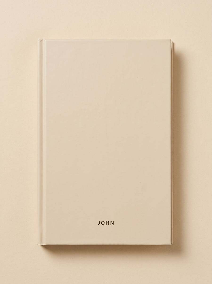 John hardcover in sand, seen from above