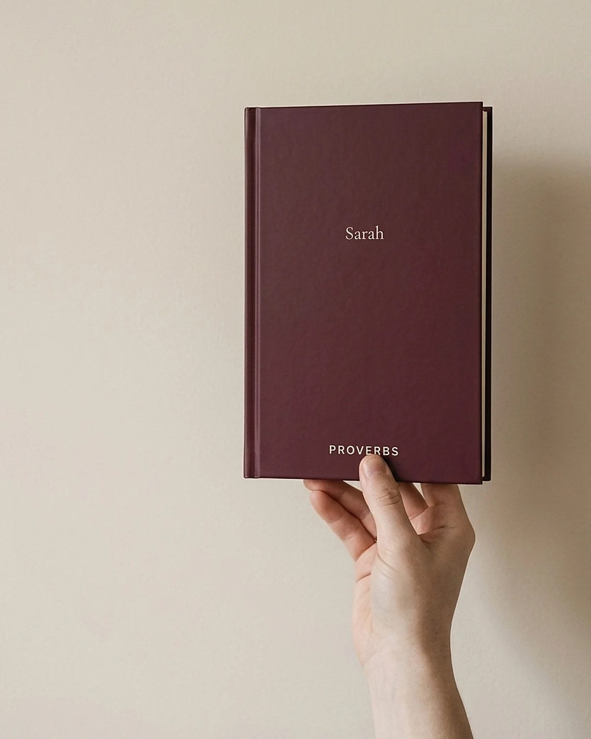 A hand holding the Proverbs hardcover, showing how big the book actually is