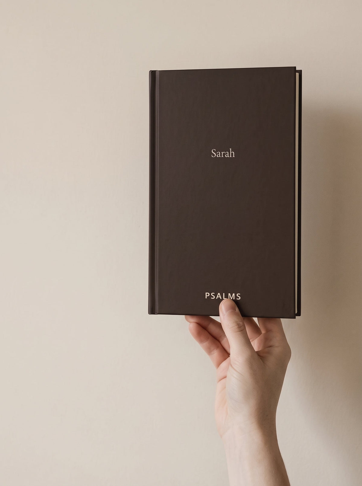 A hand holding the Psalms hardcover, showing how big the book actually is