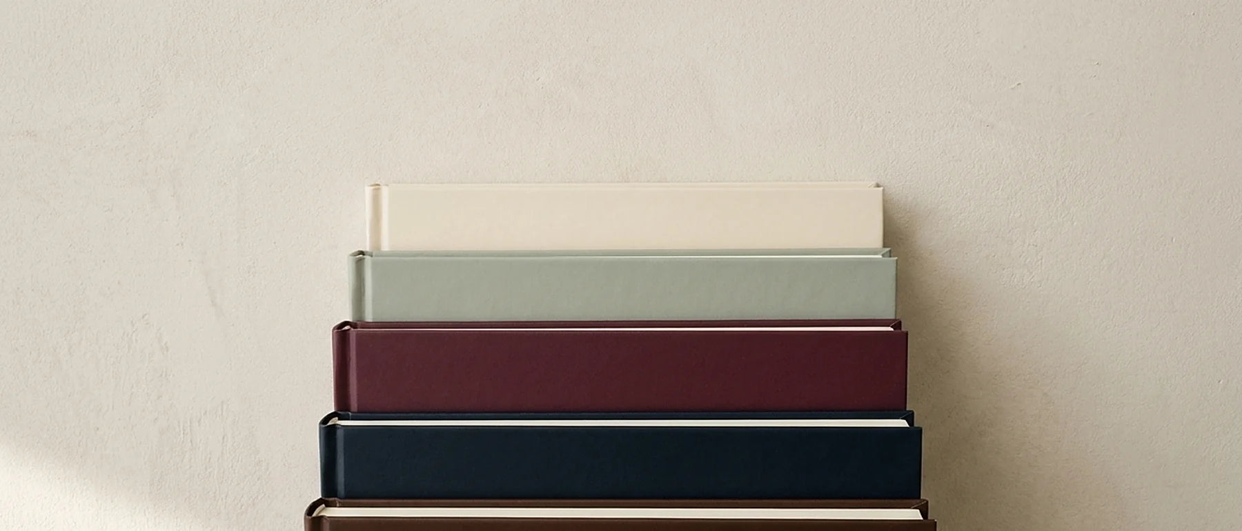 Close-up of the stacked page edges and cover boards of several copies